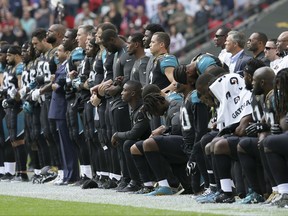FILE - In this Sept. 24, 2017, file photo, Jacksonville Jaguars NFL football players are shown, some standing an some kneeling, during the playing of the national anthem before an NFL football game against the Baltimore Ravens at Wembley Stadium in London. The Jaguars have apologized to military leaders for demonstrating during the national anthem in London last month. Jaguars President Mark Lamping sent a letter to the director of military affairs and veterans in Jacksonville saying the team was "remiss in not fully comprehending the effect of the national anthem demonstration on foreign soil has had on the men and women who have or continue to serve out country."(AP Photo/Tim Ireland, File)