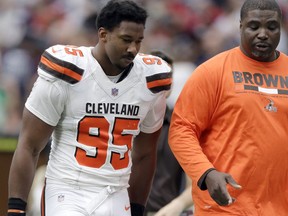 FILE - In this Oct. 15, 2017, file photo, Cleveland Browns defensive end Myles Garrett (95) walks off the field at the half during an NFL football game against the Houston Texans in Houston. Garrett has been placed in concussion protocol. The top pick in this year's NFL draft reported to the team's facility on Wednesday with concussion-like symptoms. It's unlikely he'll play in Sunday's game at London. Garrett has four sacks in three games. He missed the season's first four games with a sprained ankle. (AP Photo/Eric Gay, File)