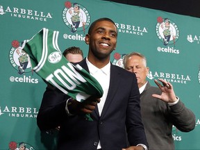 FILE - In this Friday, Sept. 1, 2017, file photo, Boston Celtics' Kyrie Irving leaves a news conference in Boston. When Irving approached Cavs owner Dan Gilbert and asked to be traded so he could get out of James' shadow, it set in motion a series of events that couldn't have been imagined. (AP Photo/Winslow Townson, File)