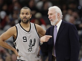 FILE - In this Dec. 30, 2016, file photo, San Antonio Spurs head coach Gregg Popovich, right, talks with guard Tony Parker (9) during the second half of an NBA basketball game against the Portland Trail Blazers in San Antonio. Parker is taking another step toward returning to the San Antonio lineup, practicing with the Spurs' G League affiliate. The Spurs' point guard hasn't played since rupturing a tendon in his left quadriceps during last season's Western Conference semifinals.  (AP Photo/Eric Gay, File)