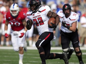 FILE - In this Oct. 7, 2017, file photo, Texas Tech running back Desmond Nisby (32) runs for a 47-yard touchdown during the first half of an NCAA college football game against Kansas, in Lawrence, Kan.  Nisby had 94 yards and four touchdowns in Texas Tech's 65-19 win last week at Kansas. He'll go up against a West Virginia defense on Saturday that has struggled to stop the run. (AP Photo/Orlin Wagner, File)