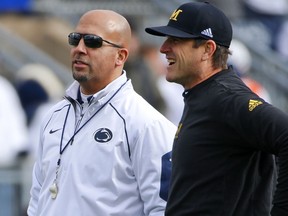 FILE - In this Nov. 21, 2015, file photo, Michigan head coach Jim Harbaugh, right, chats with Penn State head coach James Franklin before an NCAA college football game in State College, Pa. A day short of exactly one year since the victory against Ohio State, the Nittany Lions have another white out scheduled and another Big Ten power visiting for a nationally televised game. The difference this time is it will be no upset if No. 2 Penn State beats No. 19 Michigan on Saturday night. (AP Photo/Gene J. Puskar, File0