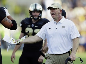 FILE - In this Sept. 23, 2017, file photo, Purdue head coach Jeff Brohm yells to an official during the first half of an NCAA college football game against Michigan in West Lafayette, Ind. While Penn State, Ohio State, Wisconsin and Michigan State head into the last Saturday of October harboring College Football Playoff hopes, several Big Ten teams that got off to promising starts now are just trying to make a bowl. Purdue matched its 2016 win total of three on Oct. 7 but hasn't won since. (AP Photo/Michael Conroy, File)