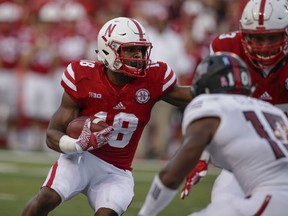 FILE - In this Sept. 2, 2017, file photo, Nebraska running back Tre Bryant (18) tries to run past Arkansas State defensive back Justin Clifton (10), during the first half of an NCAA college football game in Lincoln, Neb. Nebraska coach Mike Riley has announced that running back Tre Bryant will have knee surgery on Tuesday, Oct. 24, 2017. Bryant has missed the last five games because of the knee injury. Riley hasn't disclosed the nature of the injury, other than to say Bryant has struggled because of wear and tear on his right knee. (AP Photo/Nati Harnik, File)