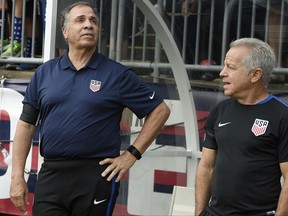 FILE - In this July 1, 2017, file photo, U.S. coach Bruce Arena, left, and assistant coach Dave Sarachan watch team introductions for an international friendly soccer match against Ghana in East Hartford, Conn. Sarachan, the top assistant to Arena, will be the interim coach for the United States when the Americans play an exhibition at European champion Portugal on Nov. 14. Arena quit Oct. 13, three days after the Americans lost 2-1 at 99th-ranked Trinidad and Tobago and failed to qualify for next year's World Cup. (AP Photo/Jessica Hill, File)