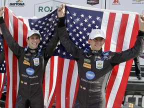 FILE - In this Sunday, Jan. 29, 2017, file photo, brothers Ricky Taylor, left, and Jordan Taylor celebrate in Victory Lane after their team won the IMSA 24-hour auto race at Daytona International Speedway in Daytona Beach, Fla.  IMSA Prototype champion Ricky Taylor will join Team Penske's full-time sports car driver lineup. Taylor will team with three-time Indianapolis 500 champion Helio Castroneves in one of the two full-time entries in the IMSA SportsCar championship next season.  (AP Photo/John Raoux, File)