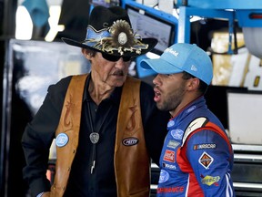 FILE - In this June 9, 2017, file photo, Richard Petty, left, and Darrell Wallace Jr. chat during practice for Sunday's NASCAR Cup series auto race in Long Pond, Pa. Wallace will drive Petty's iconic No. 43 full-time in the NASCAR Cup Series next year, the team announced Wednesday, Oct. 25, 2017. (AP Photo/Matt Slocum, File)
