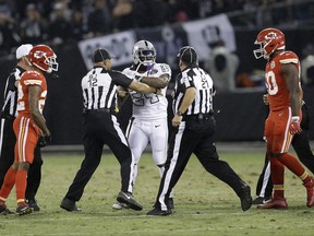 FILE - In this Oct. 19, 2017, file photo, Oakland Raiders running back Marshawn Lynch (24) makes contact with back judge Greg Steed (12) during the first half of an NFL football game between the Raiders and the Kansas City Chiefs in Oakland, Calif., Thursday, Oct. 19, 2017. Lynch was ejected after the play. (AP Photo/Ben Margot, File)