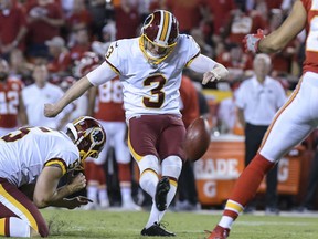 This photo taken Oct. 2, 2017, shows Washington Redskins kicker Dustin Hopkins (3) kicking a point-after during the second half of an NFL football game in Kansas City, Mo. (AP Photo/Reed Hoffmann)