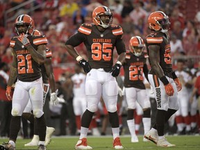 FILE - In this Aug. 26, 2017, file photo, Cleveland Browns cornerback Jamar Taylor (21), defensive end Myles Garrett (95), cornerback Joe Haden (23) and outside linebacker Jamie Collins (51) line up for a play during the first half of an NFL preseason football game against the Tampa Bay Buccaneers, in Tampa, Fla.  Deprived of making his NFL regular-season debut for a month because of a badly sprained right ankle, Garrett, the top overall pick in this year's NFL draft is expected to play against the New York Jets on Sunday, Oct. 8. (AP Photo/Phelan M. Ebenhack, File)