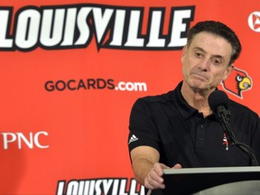FILE - In this Oct. 3, 2015, file photo, Louisville head coach Rick Pitino responds to a question following an NCAA college basketball team's intrasquad scrimmage in Louisville, Ky. Louisville's Athletic Association has officially fired coach Rick Pitino, Monday, Oct. 16, 2017,  nearly three weeks after the school acknowledged that its men's basketball program is being investigated as part of a federal corruption probe.(AP Photo/Timothy D. Easley, File)