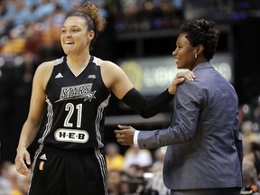 FILE - In this July 12, 2017, file photo, San Antonio Stars' Kayla McBride laughs with head coach Vickie Johnson during the second half of a WNBA basketball game against the Indiana Fever, in Indianapolis. The WNBA says the San Antonio Stars are being bought by MGM Resorts International and moving to Las Vegas, joining the NFL and NHL with teams tied to the gambling mecca. The Stars will begin play next season with home games at the Mandalay Bay Events Center. (AP Photo/Darron Cummings, File)