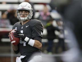 FILE - In this Sept. 23, 2017, file photo, Washington State quarterback Luke Falk (4) looks for a receiver during the second half of an NCAA college football game against Nevada in Pullman, Wash. Falk didn't draw a lot of recruiting interest out of high school in Logan, Utah. But the former walk-on at No. 8 Washington State has blossomed into a Heisman Trophy candidate as the undefeated Cougars raise eyebrows across the college football world.  (AP Photo/Young Kwak, File)