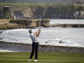 FILE - In this Feb. 14, 2016, file photo, Vaughn Taylor chips the ball up to the 18th green of the Pebble Beach Golf Links during the final round of the AT&T Pebble Beach National Pro-Am golf tournament in Pebble Beach, Calif. Prestigious Pebble Beach will host its first U.S. Women's Open in 2023 and the U.S. Open in 2027. The USGA announced the two tournaments slated for Pebble Beach on Tuesday, Oct. 24, 2017. (AP Photo/Eric Risberg, File)