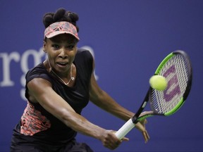FILE - In this Sept. 7, 2017, file photo, Venus Williams, of the United States, returns a shot from Sloane Stephens, of the United States, during the semifinals of the U.S. Open tennis tournament in New York. Williams needed three match points and more than three hours to defeat Jelena Ostapenko 7-5, 6-7 (3), 7-5 at the WTA Finals in Singapore on Tuesday, Ot. 24, 2017.  (AP Photo/Julio Cortez, File)