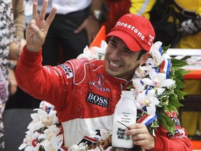 FILE - In this May 24, 2009, file photo, Helio Castroneves, of Brazil, holds up three fingers after winning his third Indianapolis 500 auto race, at Indianapolis Motor Speedway in Indianapolis, Ind. Three-time Indianapolis 500 winner Helio Castroneves will move to Team Penske's sports car program next season, bringing his 20-year full-time IndyCar career to an end. Castroneves will still drive for Penske at the Indianapolis 500. (AP Photo/Darron Cummings, File)