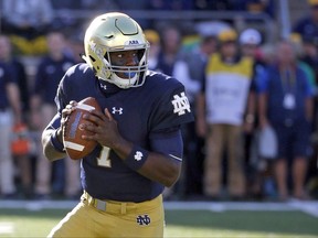 FILE - In this Sept. 30, 2017, file photo, Notre Dame quarterback Brandon Wimbush rolls out to pass during the first half of an NCAA college football game against Miami (Ohio) in South Bend, Ind. Notre Dame will have Wimbush ready for Saturday's home game against No. 11 Southern California. Coach Brian Kelley says Wimbush is "100 percent" after missing the win over North Carolina two weeks ago because of a foot injury.  (AP Photo/Charles Rex Arbogast, File)