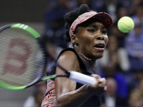 FILE - In this Sept. 7, 2017, file photo, Venus Williams returns a shot from Sloane Stephens during the semifinals of the U.S. Open tennis tournament,in New York. Venus Williams reached the semifinals at the WTA Finals by beating Wimbledon champion Garbine Muguruza 7-5, 6-4 on Thursday, Oct. 26, 2017. (AP Photo/Adam Hunger, File)