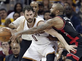 FILE - In this May 1, 2017, file photo, Cleveland Cavaliers' Kevin Love, left, tries to keep the ball from Toronto Raptors' P.J. Tucker during the first half in Game 1 of a second-round NBA basketball playoff series in Cleveland. Love, who has been the subject of trade speculation for three years in Cleveland, will be the club's new starting center, coach Tyronn Lue announced Monday night, Oct. 2, after the team played an intrasquad scrimmage at Quicken Loans Arena. Lue has experimented with Love at center during training camp and likes how it opens the floor for LeBron James and others. (AP Photo/Tony Dejak, File)