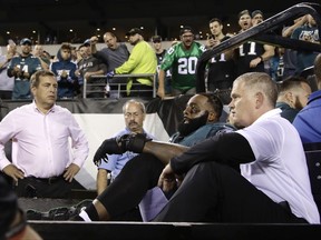 FILE - In this Monday, Oct. 23, 2017, file photo, fans cheer as Philadelphia Eagles offensive tackle Jason Peters, second from bottom right, is carted off the field during the second half of an NFL football game against the Washington Redskins in Philadelphia. Eagles coach Doug Pederson says Peters and starting linebacker Jordan Hicks will miss the rest of the season after being injured in Monday's 34-24 win over Washington. (AP Photo/Matt Rourke, File)