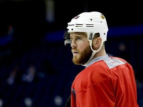 FILE - In this June 5, 2015, file photo, Chicago Blackhawks left wing Bryan Bickell watches during practice at the NHL hockey Stanley Cup Final against Tampa Bay, in Tampa, Fla. Bickell has signed a one-day contract so he can retire with the Blackhawks. Bickell was selected by Chicago in the second round of the 2004 draft and spent his first nine seasons with the Blackhawks, winning three Stanley Cup championships. He was traded to Carolina in June 2016. The 31-year-old Bickell was diagnosed with multiple sclerosis last November and played in just 11 games with the Hurricanes. (AP Photo/Chris Carlson, File)