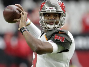 FILE - In this Oct. 15, 2017, file photo, Tampa Bay Buccaneers quarterback Jameis Winston warms up prior to an NFL football game against the Arizona Cardinals, in Glendale, Ariz.  Winston tested his injured throwing shoulder in practice and will start Sunday's game against the Buffalo Bills. Buccaneers coach Dirk Koetter made the announcement Friday, Oct. 20, 2017. (AP Photo/Rick Scuteri, File)