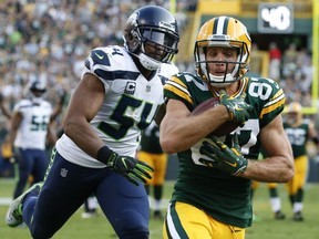 FILE - In this Sept. 10, 2017, file photo, Green Bay Packers' Jordy Nelson catches a touchdown pass in front of Seattle Seahawks' Bobby Wagner during the second half of an NFL football game, in Green Bay, Wis. Few receivers in the NFL are as productive inside the 20 as Green Bay Packers receiver Jordy Nelson. Four of his five touchdown catches this year already are in the red zone. (AP Photo/Mike Roemer, File)