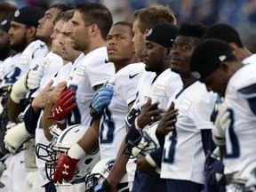 FILE - In this Aug. 8, 2016, file photo, Tennessee Titans wide receiver Rishard Matthews, center, and teammates listen to the national anthem before a scrimmage at NFL football training camp in Nashville, Tenn. Matthews spoke Friday, Oct. 13, 2017, and said he made a bad decision to tweet out that he would quit playing football if the NFL puts in a new rule on the national anthem. He quickly deleted the tweet, which someone caught via screen grabs.(AP Photo/Mark Zaleski, File)