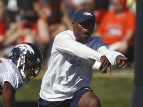 FILE - In this July 27, 2017, file photo, Denver Broncos defensive coordinator Joe Woods takes part in drills during an NFL football training camp, in Englewood, Colo. Denver's dominant defense had one fatal flaw last season. It was too predictable. Enter Joe Woods, who pledged upon succeeding his mentor, Wade Phillips, as defensive coordinator, to keep the foundation but "sprinkle a little sugar on it." (AP Photo/David Zalubowski, File)