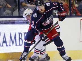 FILE - In this Sept. 19, 2017, file photo, Columbus Blue Jackets forward Artemi Panarin, right, of Russia, works for the puck against Chicago Blackhawks forward Laurent Dauphin during a preseason NHL hockey game in Columbus, Ohio. Panarin and rookie Pierre-Luc Dubois are among the newcomers who will skate for the Columbus Blue Jackets when they host the New York Islanders in the season opener Friday night.  (AP Photo/Paul Vernon)