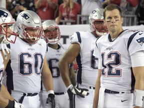 FILE - In this Thursday, Oct. 5, 2017, file photo, New England Patriots quarterback Tom Brady (12) waits to run onto the field with his teammates during team introductions before an NFL football game against the Tampa Bay Buccaneers in Tampa, Fla. Brady is telling New England fans not to worry about the left shoulder injury that kept him out of practice earlier in the week. Brady says he'll be on the field Sunday to play the New York Jets in a fight for first place in the AFC East. (AP Photo/Phelan M. Ebenhack, File)