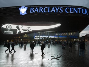 FILE - This Oct. 15, 2012 file photo shows spectators arriving at the Barclays Center in the Brooklyn borough of New York. Islanders owner Jon Ledecky said the team will play at Barclays Center through the end of next season, and the 'singular focus' beyond that is for a new arena at Belmont Park, Tuesday, Oct. 10, 2017. (AP Photo/John Minchillo, File)