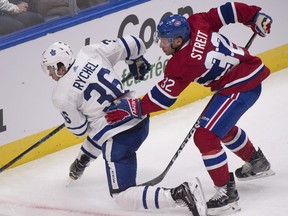 FILE- In this Sept. 27, 2017, file photo, Montreal Canadiens' Mark Streit, right, pushes Toronto Maple Leafs' Kerby Rychel during the second period of a preseason NHL hockey game in Quebec City, Quebec. A person with direct knowledge of the move tells The Associated Press the Canadiens have placed Streit on waivers. The person spoke on the condition of anonymity Wednesday, Oct. 12, 2017, because the Canadiens have not announced the move. The abrupt move comes four months after Montreal signed the 39-year-old Streit to a one-year contract in free agency (Jacques Boissinot/The Canadian Press via AP, File)