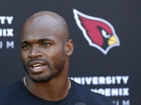 FILE - In this Oct. 11, 2017, file photo, Arizona Cardinals running back Adrian Peterson answers a question during an NFL football news conference at the team's training facility in Tempe, Ariz.  The Cardinals host the Tampa Bay Buccaneers on Sunday. (AP Photo/Ross D. Franklin, File)