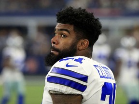 FILE - In this Oct. 12, 2017, file photo, Dallas Cowboys' Ezekiel Elliott stands on the sideline in the first half of a preseason NFL football game against the Indianapolis Colts in Arlington, Texas. A federal appeals court on Thursday, Oct. 12, 2017, has lifted an injunction that blocked a six-game suspension for  Elliott, clearing the way for the NFL's punishment over domestic violence allegations and likely leading to the running back's legal team seeking further relief.(AP Photo/Ron Jenkins, File)