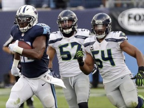 FILE - In this Sept. 24, 2017, file photo, Tennessee Titans running back DeMarco Murray, left, leaves Seattle Seahawks defenders behind as he scores on a 75-yard touchdown run in the second half of an NFL football game in Nashville, Tenn. Murray, who led the AFC in rushing last season, is averaging 5.1 yards per carry. The Titans face the Miami Dolphins on Sunday. (AP Photo/James Kenney, File)