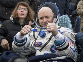 FILE - In this Wednesday, March 2, 2016 photo provided by NASA, International Space Station (ISS) crew member Scott Kelly of the U.S. reacts after landing near the town of Dzhezkazgan, Kazakhstan. In his new autobiography, the retired astronaut writes about his U.S. record-breaking year in space and the challenging life events that got him there. (Bill Ingalls/NASA via AP)