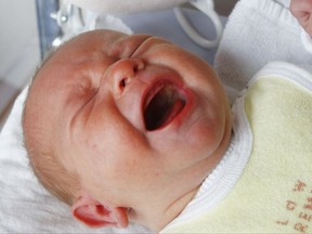 FILE - In this Wednesday, Nov. 12, 2008 file photo, a baby cries in its bed in a hospital in Bremen, northern Germany. According to as study released on Monday, Oct. 23, 2017 by the Proceedings of the National Academy of Sciences, the way a mother responds to her crying baby seems to be programmed into her brain circuits. Researchers found that mothers across many cultures tend to react the same way to an infant's cry, and brain scans showed that this distressing sound activates circuitry associated with such responses. (AP Photo/Joerg Sarbach)