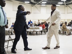 Paulette Carrington, left, and fellow juvenile lifer Courtney Boyd, both participants in Uplift Solutions' job training program for former inmates, walk to embrace each other during their graduation ceremony in Philadelphia, Monday, Oct. 16, 2017. The release of dozens of former juvenile lifers, set in motion by a U.S. Supreme Court ruling, raises a host of questions about how those freed will navigate life on the outside. (AP Photo/Matt Rourke)