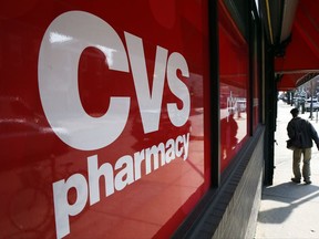 FILE - This March 25, 2014, file photo shows a CVS store and pharmacy in Philadelphia. According to a Thursday, Oct. 26, 2017 report in The Wall Street Journal., the drugstore chain is in talks to buy Aetna, the nation's third-largest insurer. Analysts say such a deal would create a health colossus that can reach deeper into the average customer's life to manage care and cut costs. (AP Photo/Matt Rourke, File)