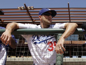 FILE - In this March 24, 2011, file photo, Los Angeles Dodgers' Gabe Kapler stands in the dugout before the Dodgers' spring training baseball game against the Colorado Rockies in Glendale, Ariz. Kapler will be hired to manage the Philadelphia Phillies, according to a person familiar with the decision. The person spoke to The Associated Press on condition of anonymity because an official announcement hasn't been made. (AP Photo/Nam Y. Huh, File)