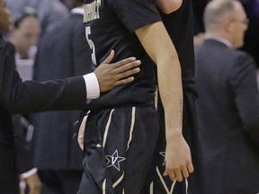 FILE - In this March 16, 2017, file photo, Vanderbilt's Luke Kornet, right, consoles guard Matthew Fisher-Davis (5) following the team's 68-66 loss to Northwestern in a first-round game of the NCAA men's college basketball tournament in Salt Lake City. Fisher-Davis is probably best remembered for rallying Vanderbilt from 15 points down in the NCAA Tournament last March before inexplicably fouling Northwestern's Bryant McIntosh on purpose in a painful loss. Fisher-Davis says he doesn't want that to be the last experience he has in the NCAA Tournament. (AP Photo/Rick Bowmer, File)