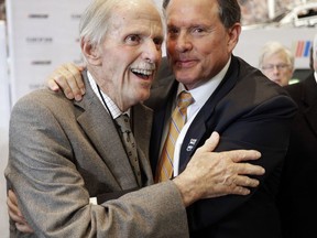 FILE - In this May 24, 2017, file photo, former team owner Robert Yates, left, is congratulated by Winston Kelley, right, executive director of the NASCAR Hall of Fame, after being named as a member of the class of 2018 during an announcement at the NASCAR Hall of Fame in Charlotte, N.C. Yates, a longtime NASCAR owner and engine builder, has died, his son Doug Yates said on Twitter Monday, Oct. 2, 2017. He was 74. (AP Photo/Chuck Burton, File)