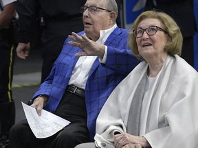 FILE - In this Wednesday, March 8, 2017, file photo, Orlando Magic owner Rich DeVos, left, waves to fans while watching court side with his wife Helen during the first half of an NBA basketball game against the Chicago Bulls in Orlando, Fla. The family of Helen DeVos said the philanthropist from western Michigan known for her support of children's health, Christian education and the arts has died. She was 90. Her family said she died Wednesday, Oct. 18, of complications from a stroke following a recent diagnosis of myeloid leukemia. (AP Photo/Phelan M. Ebenhack, File)