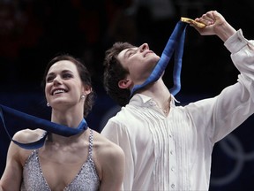 FILE - In this Feb. 22, 2010, file photo, Canada's Tessa Virtue and Scott Moir hold up their medals on the podium after winning gold in the ice dance figure skating competition at the Vancouver 2010 Olympics in Vancouver, British Columbia. The pair are the heavy favorites to win Olympic gold in ice dance at the PyeongChang Games in February 2018. That quest begins with Skate Canada, an event they won handily last year. (AP Photo/Ivan Sekretarev, File)