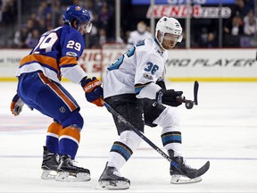 San Jose Sharks' Jannik Hansen (36) battles for the puck with New York Islanders' Brock Nelson (29) in the first period of an NHL hockey game, Saturday, Oct. 21, 2017, in New York. (AP Photo/Adam Hunger)