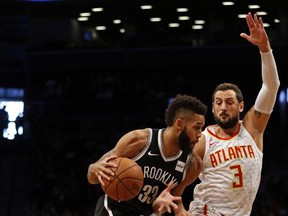Brooklyn Nets' Allen Crabbe drives to the basket past Atlanta Hawks' Marco Belinelli (3) during the first quarter of an NBA basketball game Sunday, Oct. 22, 2017, in New York. (AP Photo/Adam Hunger)