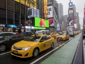 FILE - In this Thursday, May 25, 2017, file photo, traffic makes its way down Seventh Avenue in New York's Times Square. Cruise Automation, a self-driving software company owned by General Motors, will start testing in New York in early 2018. They'll have an engineer behind the wheel to monitor performance. Cruise CEO Kyle Vogt says the densely populated city will give the company more unusual situations to test software. Cruise currently is testing in San Francisco. (AP Photo/Mary Altaffer, File)