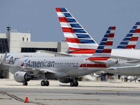 FILE - In this Wednesday, May 27, 2015, file photo, an American Airlines jet taxis to the gate at Miami International Airport, in Miami. The NAACP is warning African-Americans that if they fly on American Airlines they could be subject to discrimination or even unsafe conditions. American said Wednesday, Oct. 25, 2017, it's disappointed by the announcement and will invite the civil rights group to meet and talk about the airline. (AP Photo/Lynne Sladky, File)