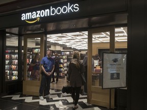 FILE - In this Thursday, May 25, 2017, file photo, a woman is greeted by an Amazon Books store employee as she arrives at the store in the Time Warner Center at Columbus Circle, in New York. Amazon.com, Inc. reports earnings Thursday, Oct. 26, 2017.  (AP Photo/Mary Altaffer, File)